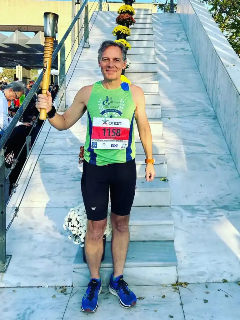 Marathon runner holding torch at finish line celebration