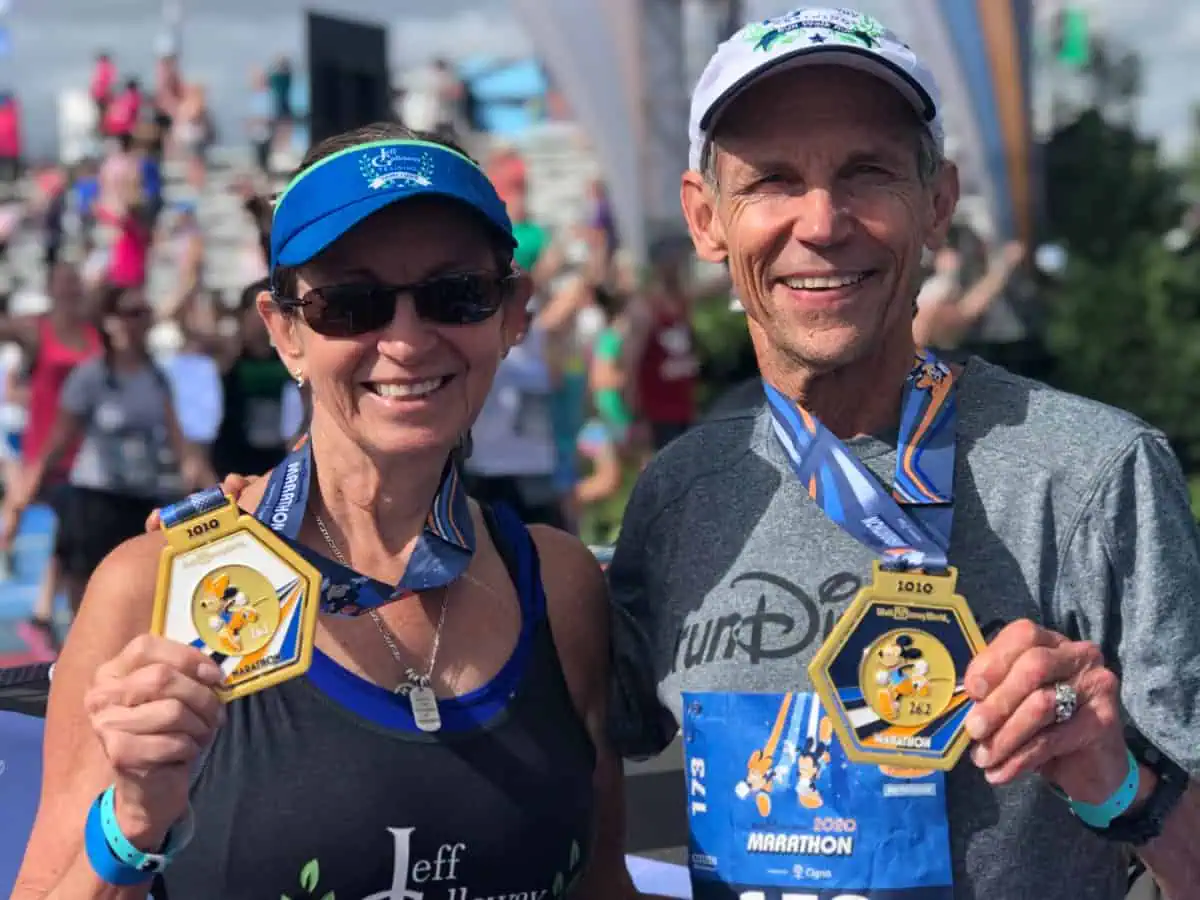 Jeff Galloway and friend celebrating with medals at marathon finish line.