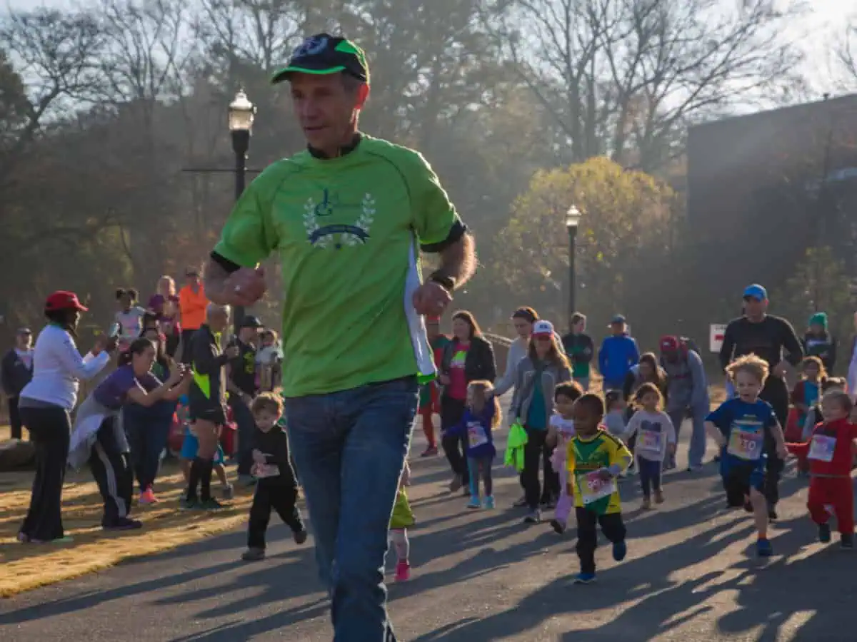 Adults and children participating in a fun run event.
